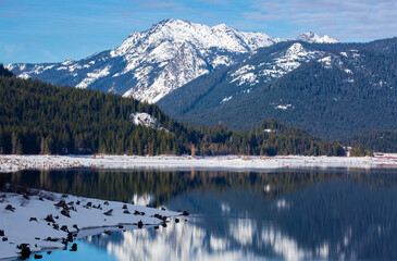 Beautiful snow-capped mountain reflections in Lake Keechelus in winter in Washington state

