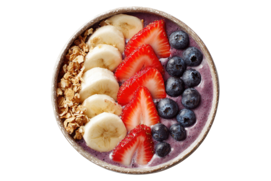 A vibrant, healthy breakfast bowl features granola, sliced banana, strawberries, and blueberries