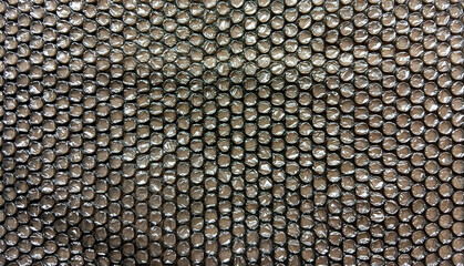 Close-up of black bubble wrap surface with soft glossy reflections and circular air cell pattern, perfect for background, packaging, or industrial design texture.