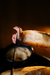 Bread with pate spread on knife in warm light