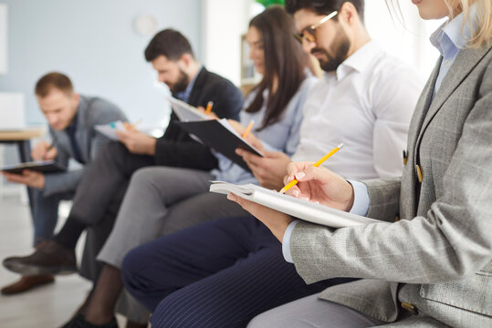 Close-up of a business people or coworkers in team working together with documents during office meeting, focusing on group collaboration in a professional setting with dedication and effort.