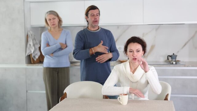 Man and mature mother yell at adult sister. Family conflict between relatives kinfolk