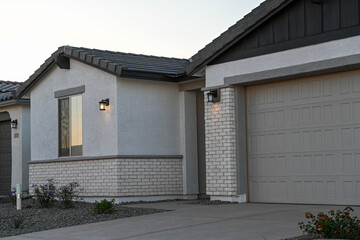 New single-story home with brick and stucco exterior, unoccupied and move-in ready, illustrating freshly completed construction in a suburban residential subdivision