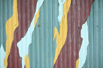 Bold abstract camouflage pattern on cracked textured wall