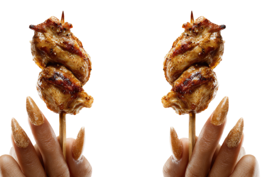 Two skewers of cooked meat are held up by manicured hands against a black backdrop