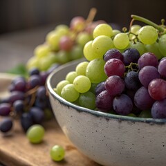 Fresh purple and green grapes in ceramic bowl with shallow depth of field natural light