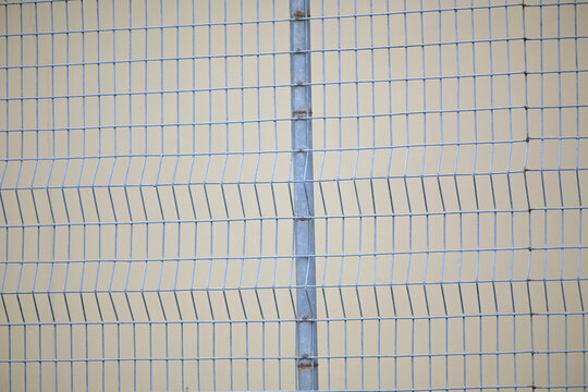 Durable wire mesh fence with metal post, modern design