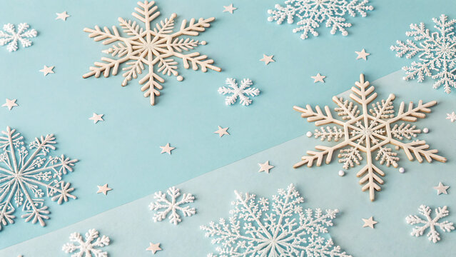 Snowflake pattern on pastel blue background. Winter abstract minimalism. Isometric flat lay.