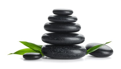 Obraz premium A tower of smooth, dark stones is carefully balanced with bamboo leaves on a stark white background for a serene presentation