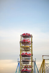Whimsical Ferris wheel delight against soft sky