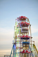 Whimsical Ferris wheel delight against soft sky