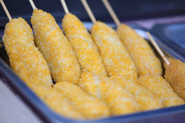 Crispy corn dogs on sticks ready for serving