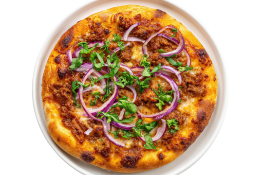 Overhead shot of a pizza with ground meat, red onion rings, and green herbs on a white plate