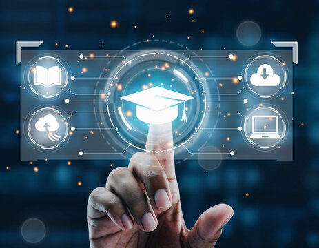 Hand touching virtual graduation cap with book cloud and laptop icons on a digital interface