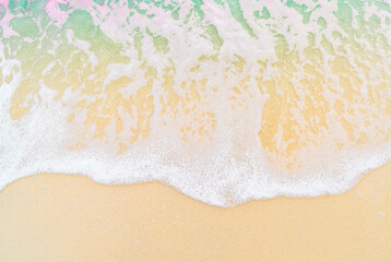 The image shows a close-up of sea foam rolling onto a sandy beach.
The clear dividing line between the foam and the dry sand creates a minimalist and abstract visual effect.