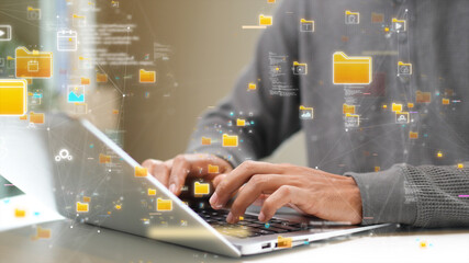 Close-up of hands typing on a laptop with floating digital file icons, representing cloud storage, data management, and online information security. technology cloud computing.