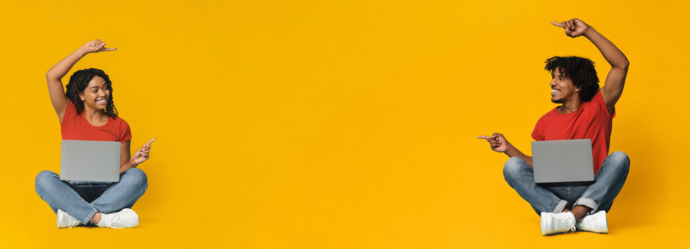 Two individuals sit on the floor with laptops. They smile and point, expressing joy and teamwork. The bright yellow backdrop adds a cheerful and energetic vibe to the scene.