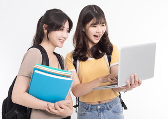 Excited Asian female students watching the laptop