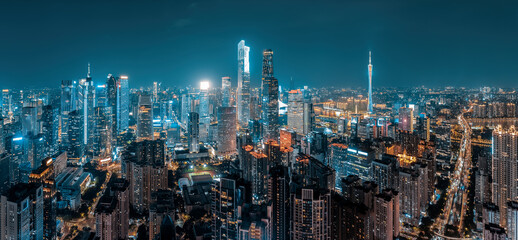 Panorama of the brightly illuminated central business district and modern city skyline at night in Guangzhou.