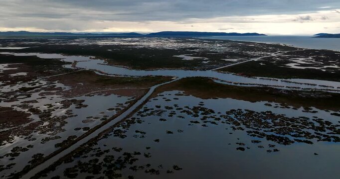Uros floating islands on Lake Titicaca, Puno, Peru. Aerial drone panoramic view