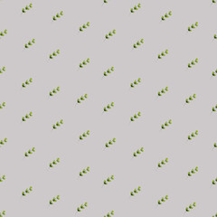 Seamless pattern with spring green leaves. Delicate watercolor print on a gray background, colorful illustration.