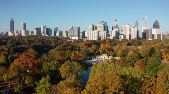 Slowly gliding over Piedmont Park viewing downtown Atlanta Georgia in the Fall
