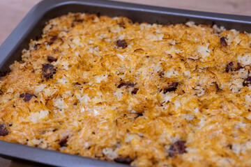 Traditional Slovak baked cabbage casserole with minced meat, sausage, rice, and sauerkraut. Homemade meal from Central Europe, known as “Koložvárska kapusta”.