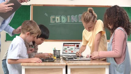 Group of diverse student working together on main board with laptop screen display engineering prompt written while teacher hold tablet and explain online software at STEM technology class. Pedagogy. - Powered by Adobe