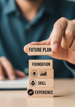 A close-up of a hand completing a career development strategy by placing the top wooden block