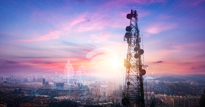 Telecommunication tower with cityscape background at sunset,panoramic view