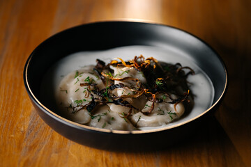 Cheesecakes with sour cream and peach slices on white plate