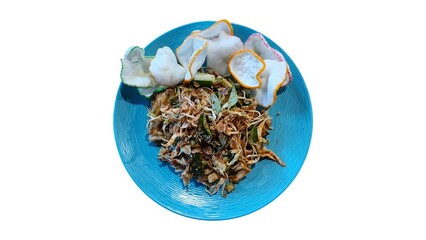 Karedok, Indonesian salad with peanut sauce, served on a blue plate with crackers. Shot on white background.