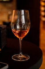 glass of wine on the table an bokeh 