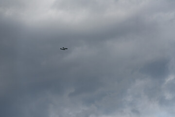 Two small planes fly through the endless cloudy sky, emphasizing its scale