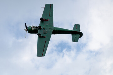 Green Propeller Aircraft in Flight, Viewed from Below