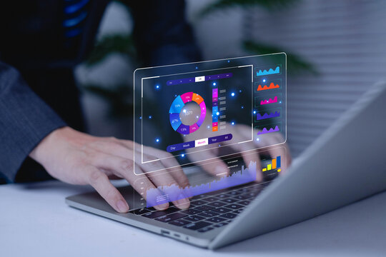 Businessman typing on laptop with digital data analytics dashboard, colorful charts, and AI interface. Concept of big data, financial technology, performance metrics, and digital transformation.