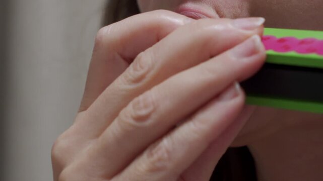 Full Melody: Hands Slide Wooden Harmonica to Play Varied Musical Notes.