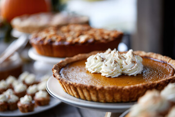 Pumpkin pies and autumn desserts on Thanksgiving table