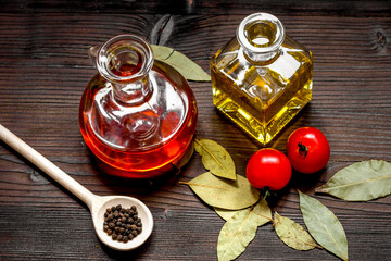 oil in glass bottle and chilli on dark wooden background