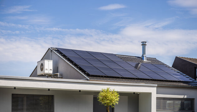 Roof of modern house with inverter split system and installed solar panels