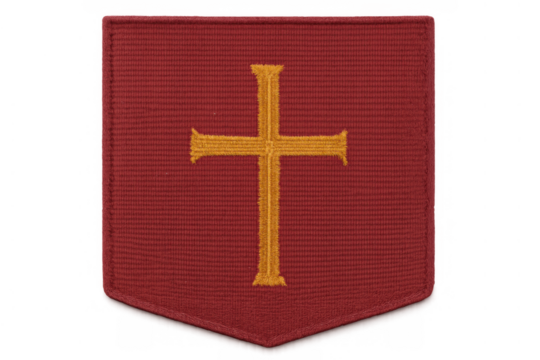 Red fabric embroidered patch depicting golden christian cross, shield shape symbolizing religion and spiritual protection, transparent background - Powered by Adobe