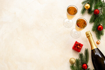 Christmas bottle of champagne with two glasses and fir tree branches, top view. Happy New Year and Merry Christmas decoration