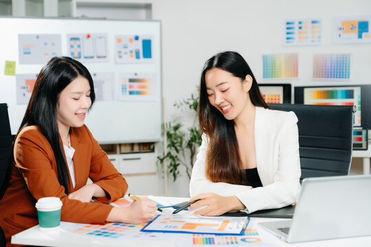 Two female designers collaborating on color palette and UX UI project in a modern creative office. Perfect for business, teamwork, and innovation themes.
