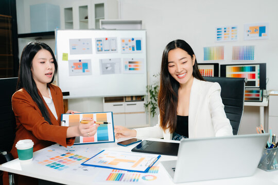 Two female designers collaborating on color palette and UX UI project in a modern creative office. Perfect for business, teamwork, and innovation themes. - Powered by Adobe
