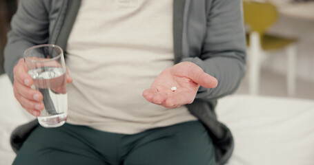 Pill, water and senior person hands in clinic for medical consultation with treatment for recovery. Healthcare, vitamins and elderly man with drugs, tablets or supplements with h2o for wellness