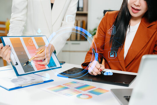 Creative female designers team using pen tablet and color palette working in graphic design Choose colors for working on tablets and computer designs. - Powered by Adobe