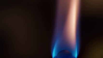 Dynamic close-up of a gas torch flame igniting, wavering, and adjusting, showcasing vibrant blue and light-orange hues video footage. - Powered by Adobe