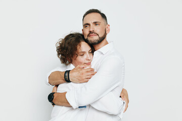 A professional man in a crisp shirt shares a warm embrace, expressing confidence and empathy against an isolated colored background; a poised business moment colored by authentic emotion and