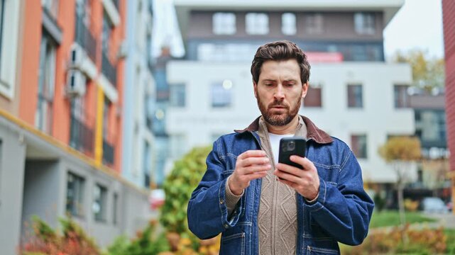 Individual standing outdoors, engaged with smartphone. Experiences confusion and worry, then looks up in contemplation before returning gaze to device. Reflects on uncertainty.