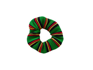Obraz premium Colorful striped fabric scrunchie with green, red, and yellow pattern, isolated on transparency background, hair accessory, vibrant and playful style for casual or festive looks